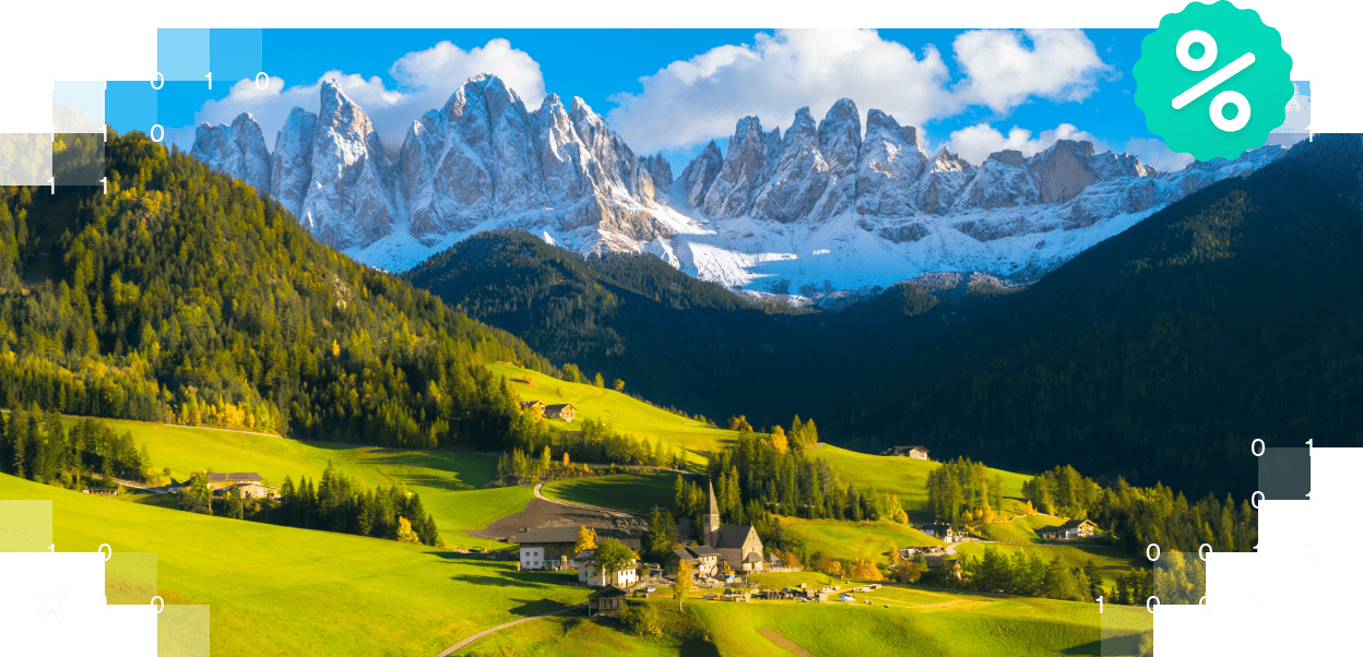 Malownicze nadmorskie miasto z kolorowymi budynkami i kilkoma łodziami zadokymi w porcie.